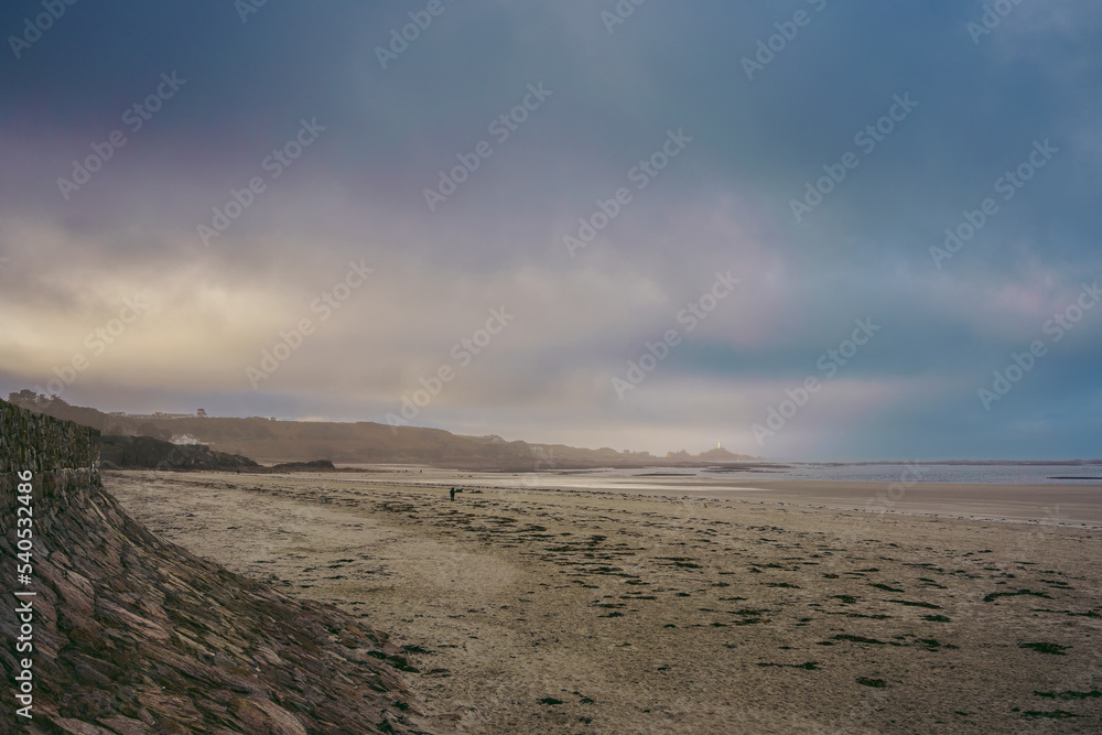 The view of La Corbière Lighthouse in Jersey from Le Braye beach. CHannel Isands