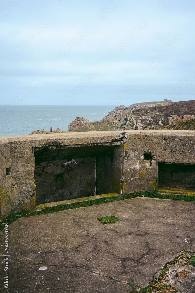 Abandoned World War II bunker on the cliffs of the island on cloudy day Abandoned World War II bunker on the cliffs of the island on cloudy day