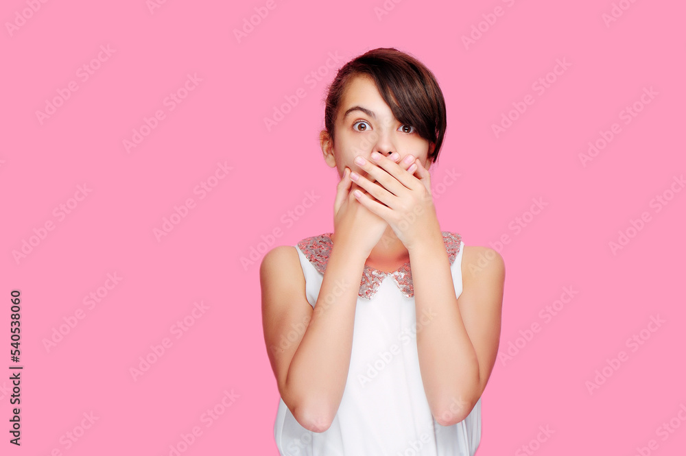 Amazed girl closing her mouth with her hands Amazed girl closing her mouth with her hands