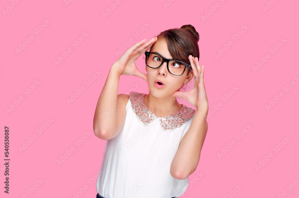 Brunette girl in a pink studio having a head spinning Brunette girl in a pink studio having a head spinning