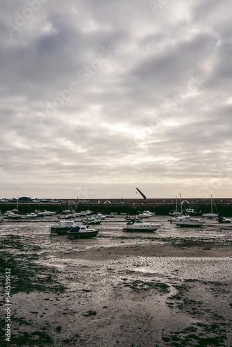 Boats moored at the seaside on cloudy day © Sandor Szmutko
