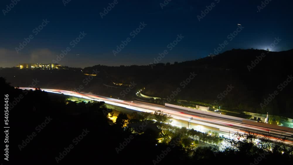 Aerial Lockdown Time Lapse Shot Of Long Exposure Of Cars Moving On Road Amidst Mountains In City - Santa Monica, California Aerial Lockdown Time Lapse Shot Of Long Exposure Of Cars Moving On Road Amidst Mountains In City - Santa Monica, California