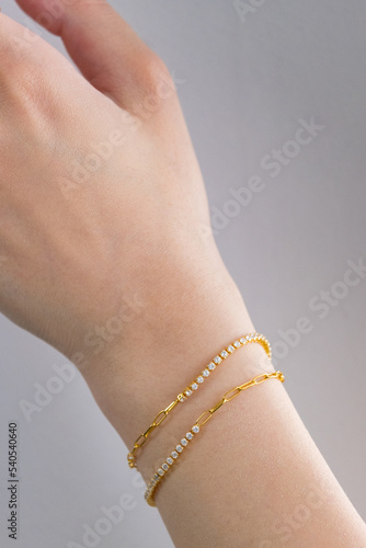 Beautuful woman wrist wearing bracelets set against white. Beautiful valentine's gifts.