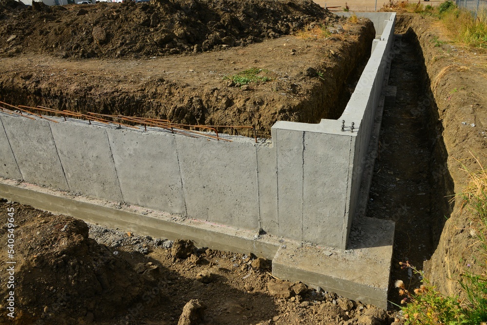 Concrete footings and foundation with anchor bolts ready for more