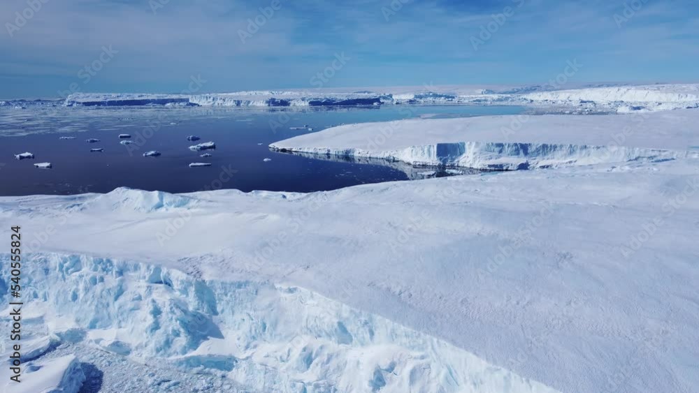 Huge high ice glacier at polar nature environment. Arctic winter landscape at global warming problem. Desert white land of snow and ice drone shot. Huge high ice glacier at polar nature environment. Arctic winter landscape at global warming problem. Desert white land of snow and ice drone shot.