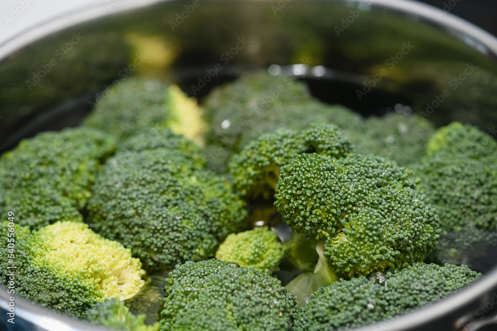 Fresh green broccoli cooked boiled in a pan. Close-up. Fresh green broccoli cooked boiled in a pan. Close-up.