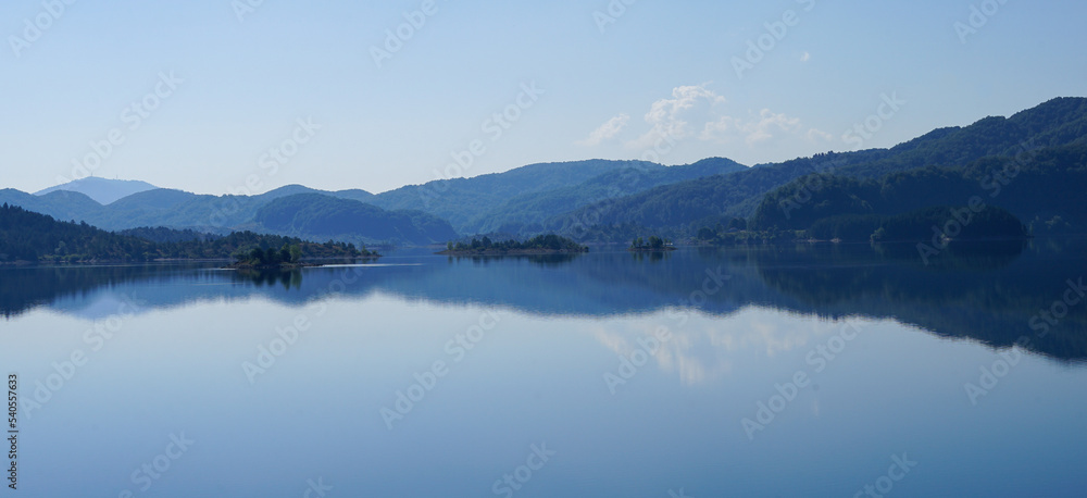 Wonderful Aoos Lake near Metsovo in Epidurs. Beautiful Mirror Reflection of the surrounding mountains in the water. Wonderful Aoos Lake near Metsovo in Epidurs. Beautiful Mirror Reflection of the surrounding mountains in the water.