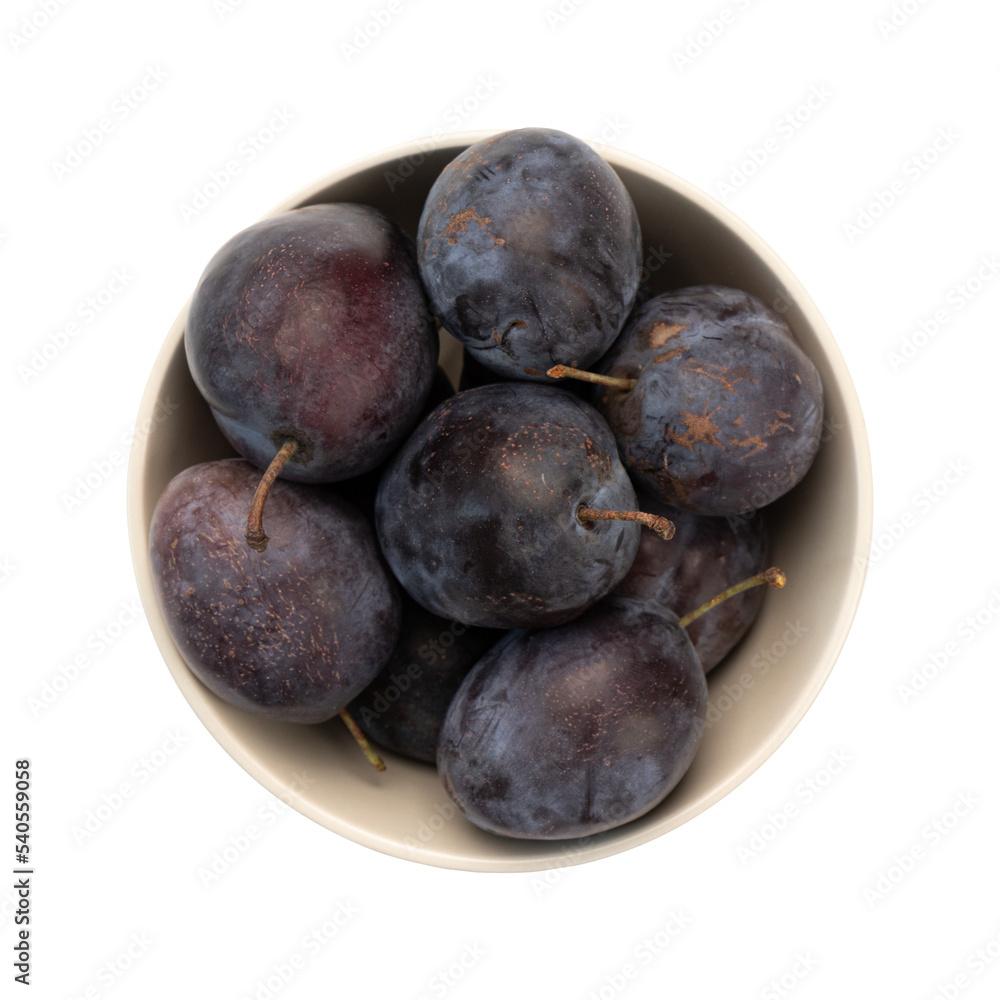 fresh ripe purple plums in ceramic bowl isolated on white background, top view