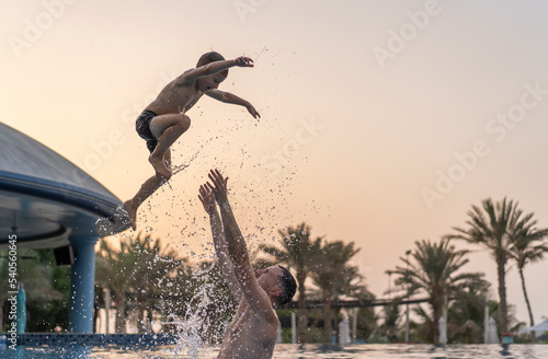 Photography Dad and son are playing in the swimming pool