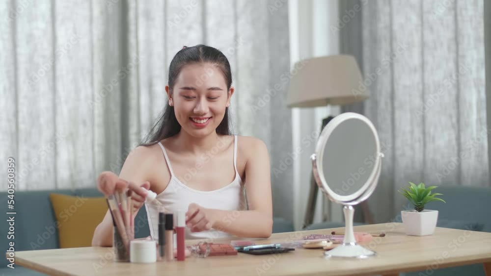 Beautiful Young Asian Woman Looks In The Mirror Applying Serum And Smiles While Wearing Makeup At Home
Beautiful Young Asian Woman Looks In The Mirror Applying Serum And Smiles While Wearing Makeup At Home