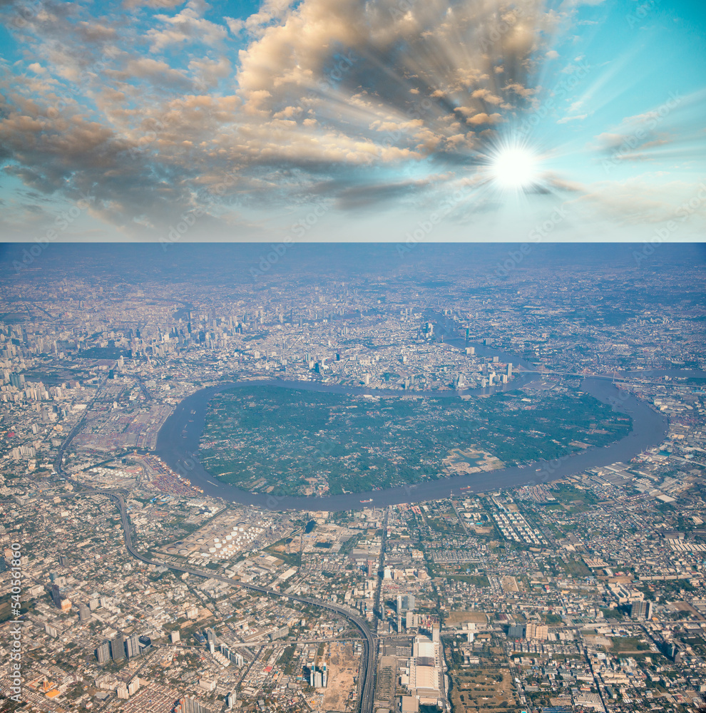 Aerial view of a metropolitan city and the main river surrounding it at sunset