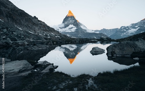 Vertical shot of a lake reflecting the Matterhorn mountain peak in Swiss