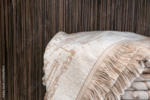 New clean towels are neatly stacked on the shelves in the store. The interior of a modern bathroom in a hotel. Shelves with bath accessories in the new relaxation room.