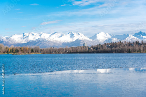 Downtown Anchorage buildings and Chugach Mountains in background from Westchester Lagoon park