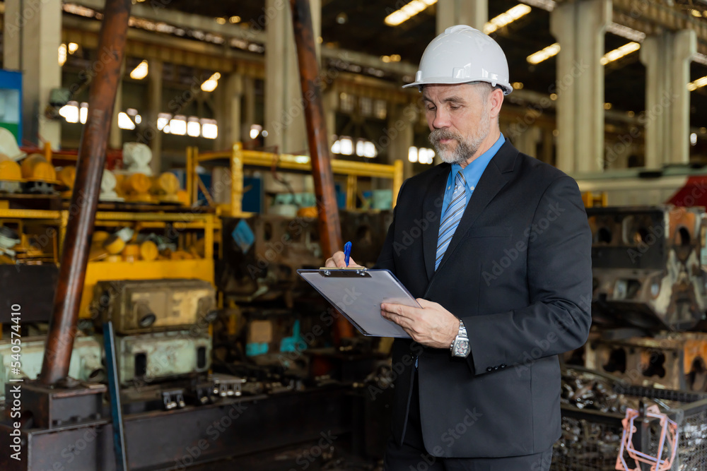 A businessman checks on-site maintenance work at an old factory for train rehearsals. A businessman checks on-site maintenance work at an old factory for train rehearsals.