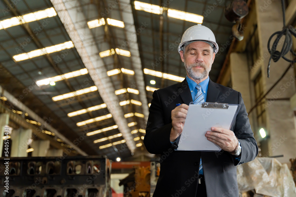 A businessman checks on-site maintenance work at an old factory for train rehearsals. A businessman checks on-site maintenance work at an old factory for train rehearsals.