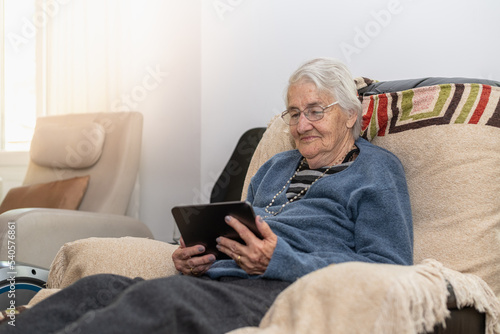 retired adult person with tablet in hand connected to technology