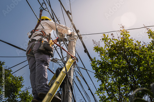 Photos unrecognizable person installer of aerial technology cable and internet with sec