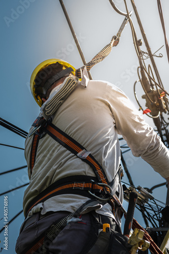 unrecognizable person installer of aerial technology cable and internet with security