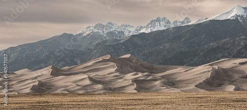 Fototapeta Naklejka Na Ścianę i Meble -  Muted Colors of Great Sand Dunes and Snowy Mountains