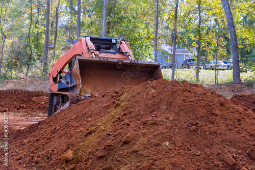 On construction sites, small tractors are used to transport soil be used for landscaping