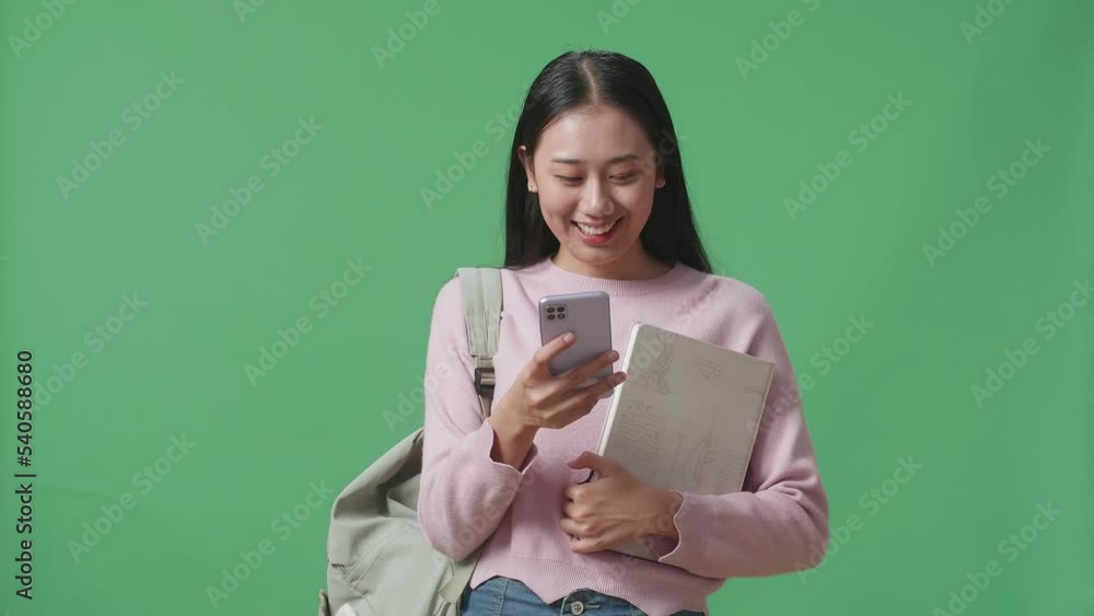 Asian Woman Student Using Mobile Phone On Green Screen Studio
Asian Woman Student Using Mobile Phone On Green Screen Studio
