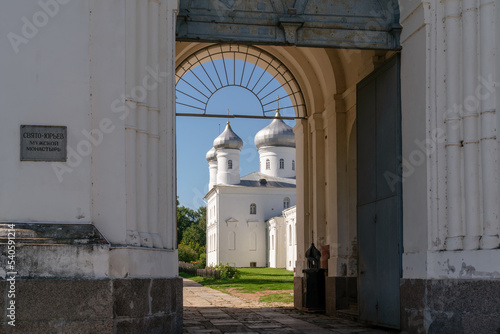 The inscription "St. George Monastery". View of the entrance to the St. George Monastery and the Spassky Cathedral in the gateway on a sunny summer day, Veliky Novgorod, Russia