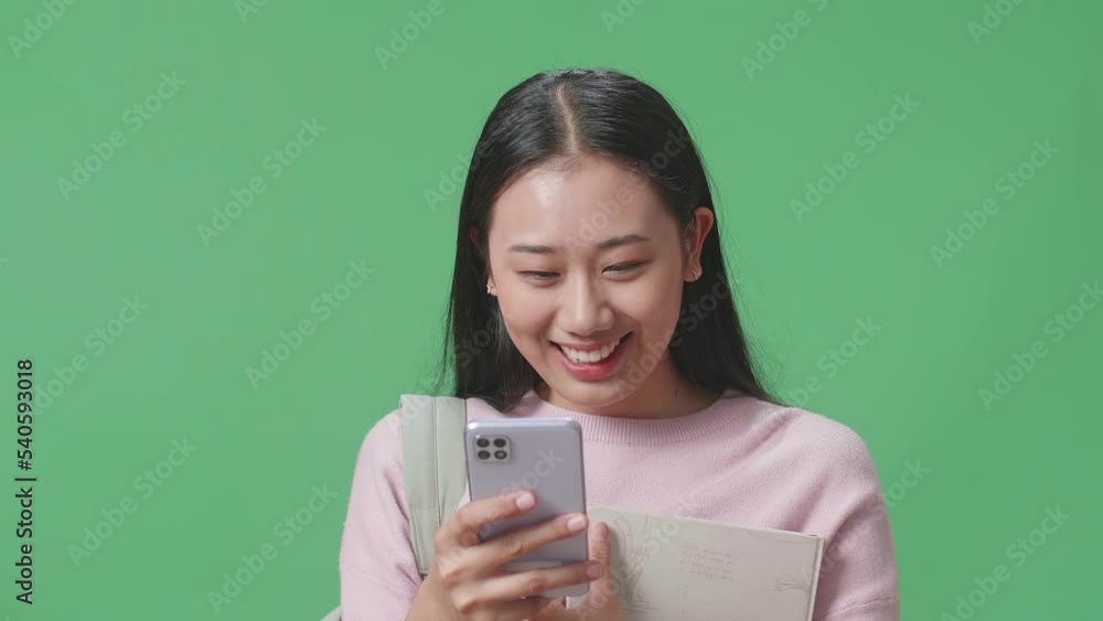 Asian Woman Student Using Mobile Phone On Green Screen Studio
Asian Woman Student Using Mobile Phone On Green Screen Studio