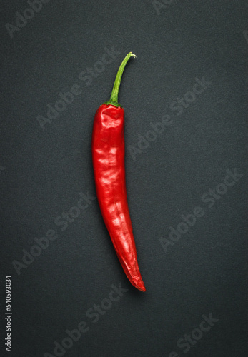 Burning red pepper on a black background.