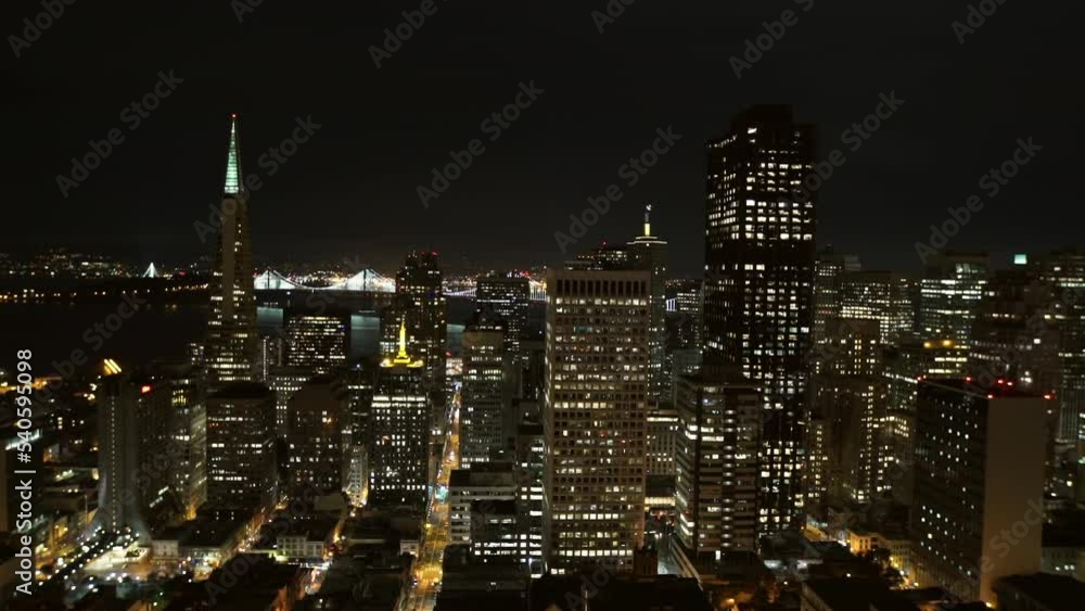 Aerial Lockdown Shot Of Illuminated Modern Buildings In City Against Clear Sky At Night - San Francisco, California Aerial Lockdown Shot Of Illuminated Modern Buildings In City Against Clear Sky At Night - San Francisco, California