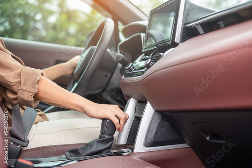 woman driver stick shift transmission a car gear, hand controlling steering wheel during vehicle moving. Journey, trip and safety Transportation concepts