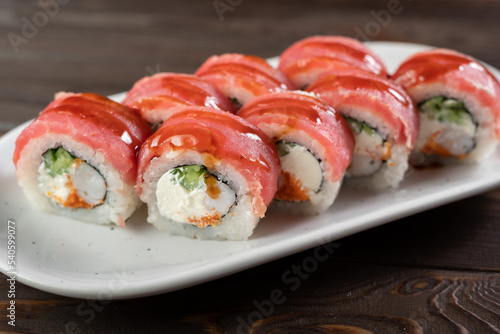 Delicious presented and freshly prepared tuna roll served on a white plate. Sushi menu
