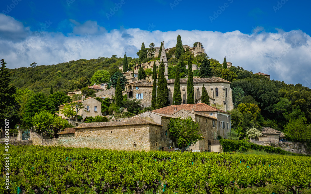 View on the medieval village of Lussan, with vineyards in the foreground in the south of France (Gard) 
