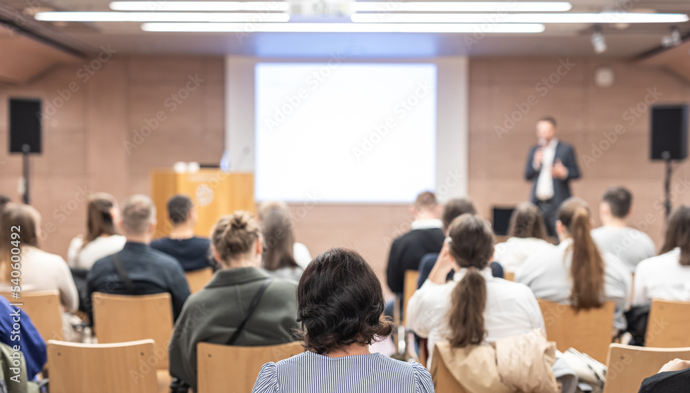 custom made wallpaper toronto digitalSpeaker giving a talk in conference hall at business event. Rear view of unrecognizable people in audience at the conference hall. Business and entrepreneurship concept.