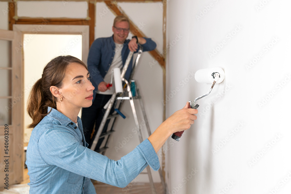 Couple husband and wife redecoreting new appartment for a family. Home improvement concept. Couple husband and wife redecoreting new appartment for a family. Home improvement concept.