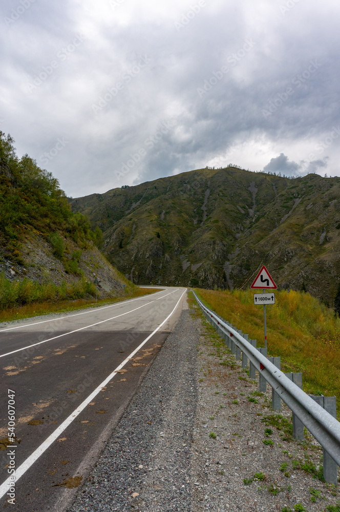 A road surrounded by mountains in the Altai Republic. Gorny Altai