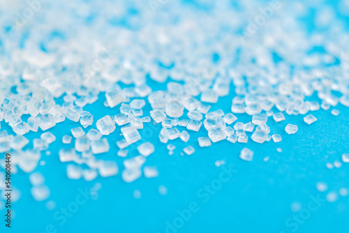 White sugar crystals on blue background