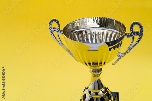 Fotografie Golden trophy on yellow background