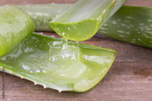 Aloe vera in a spoon on wood.