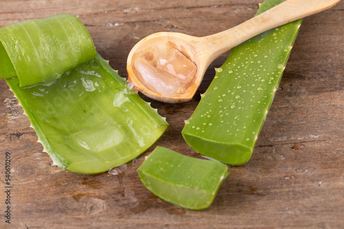 Aloe vera in a spoon on wood.