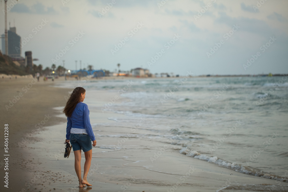 woman walking on the beach woman walking on the beach