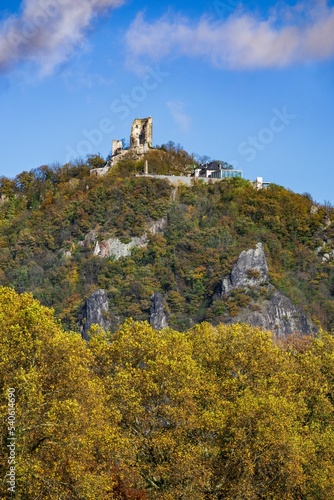 Vertical of modern building on top of a green Drachenfels mountain in Konigswinter,Germany in autumn photo
