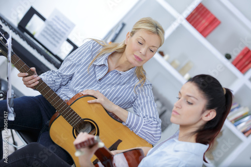 woman learning to play guitar