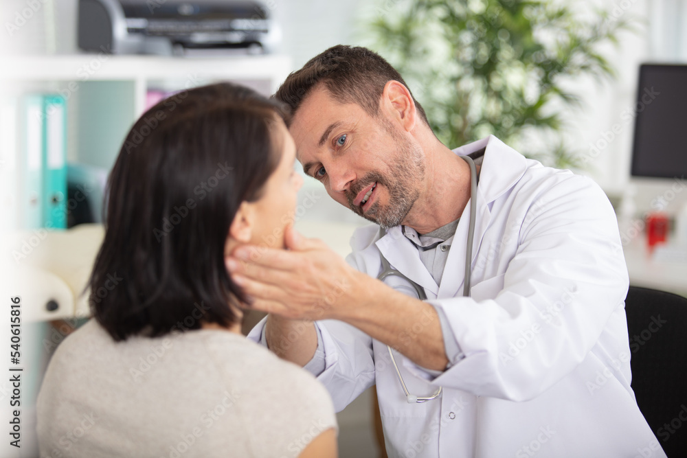 handsome doctor is talking with young female patient handsome doctor is talking with young female patient