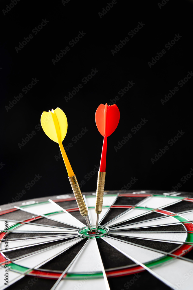 Two darts hitting on center target Two darts hitting on center target