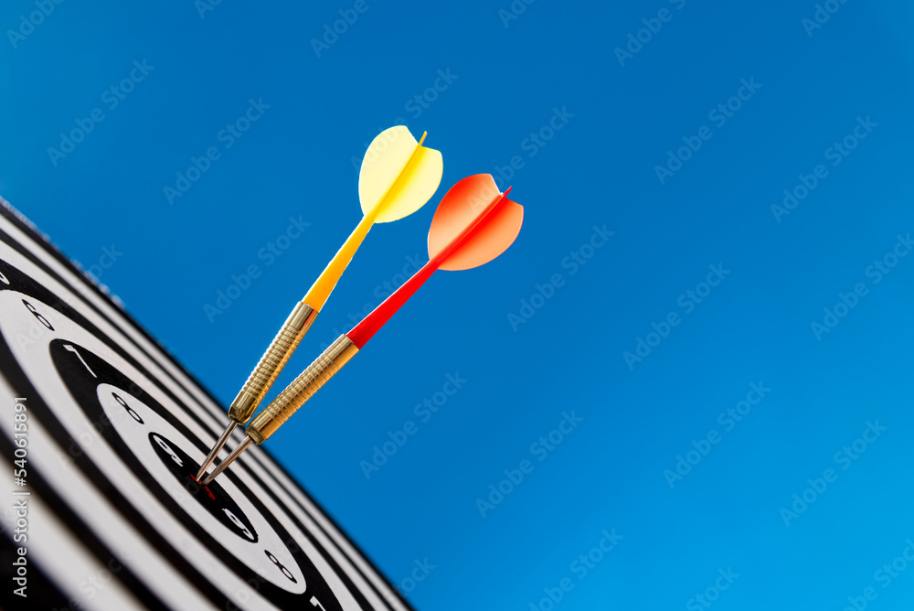 Two darts hitting on center target Two darts hitting on center target