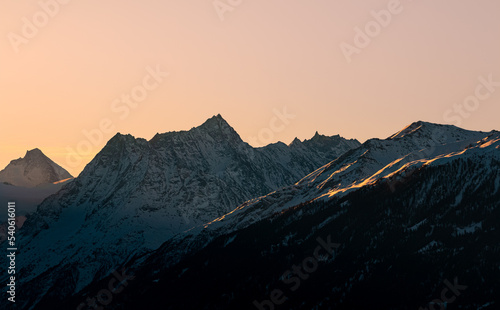 Late sunrise in the swiss alps during winter