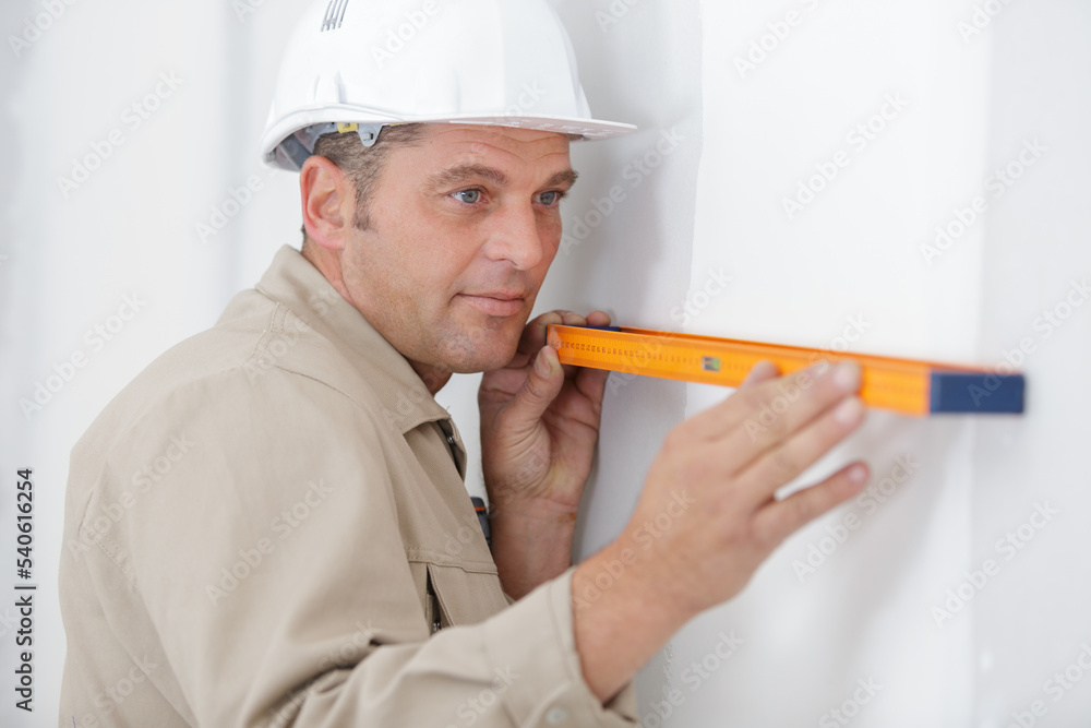 builder man with level mixed media builder man with level mixed media