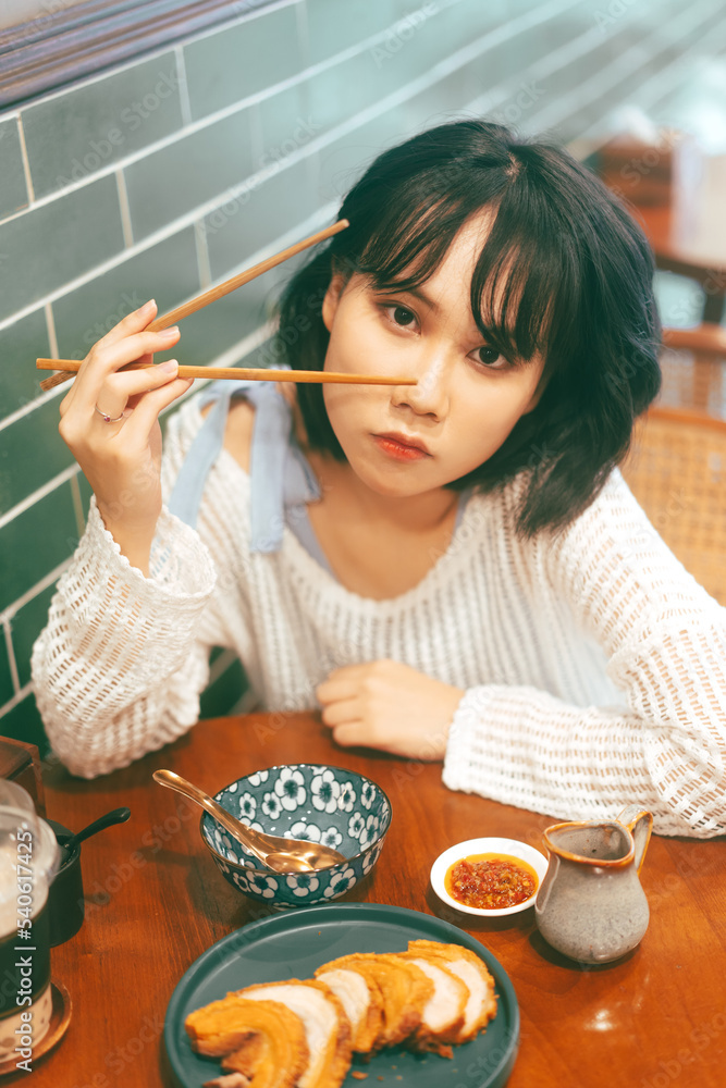 Portrait of young adult asian woman with 80s style japanese fashion in retro chinese cafe Portrait of young adult asian woman with 80s style japanese fashion in retro chinese cafe