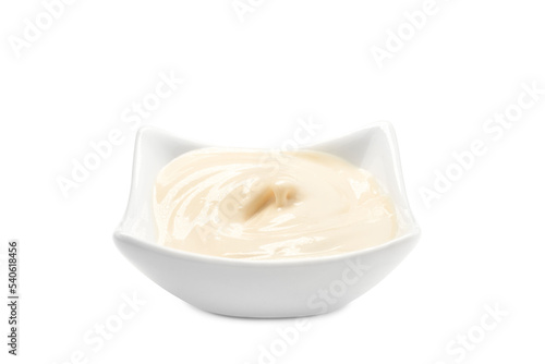 A bowl filled with mayonnaise on a white background